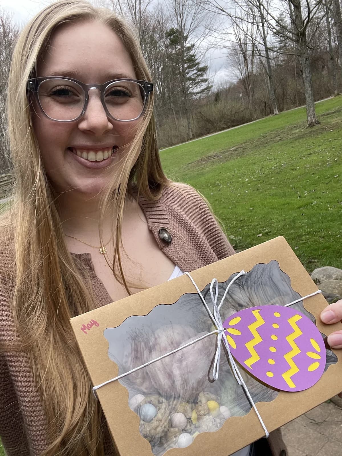 Tess holding a TES Treats cookie box